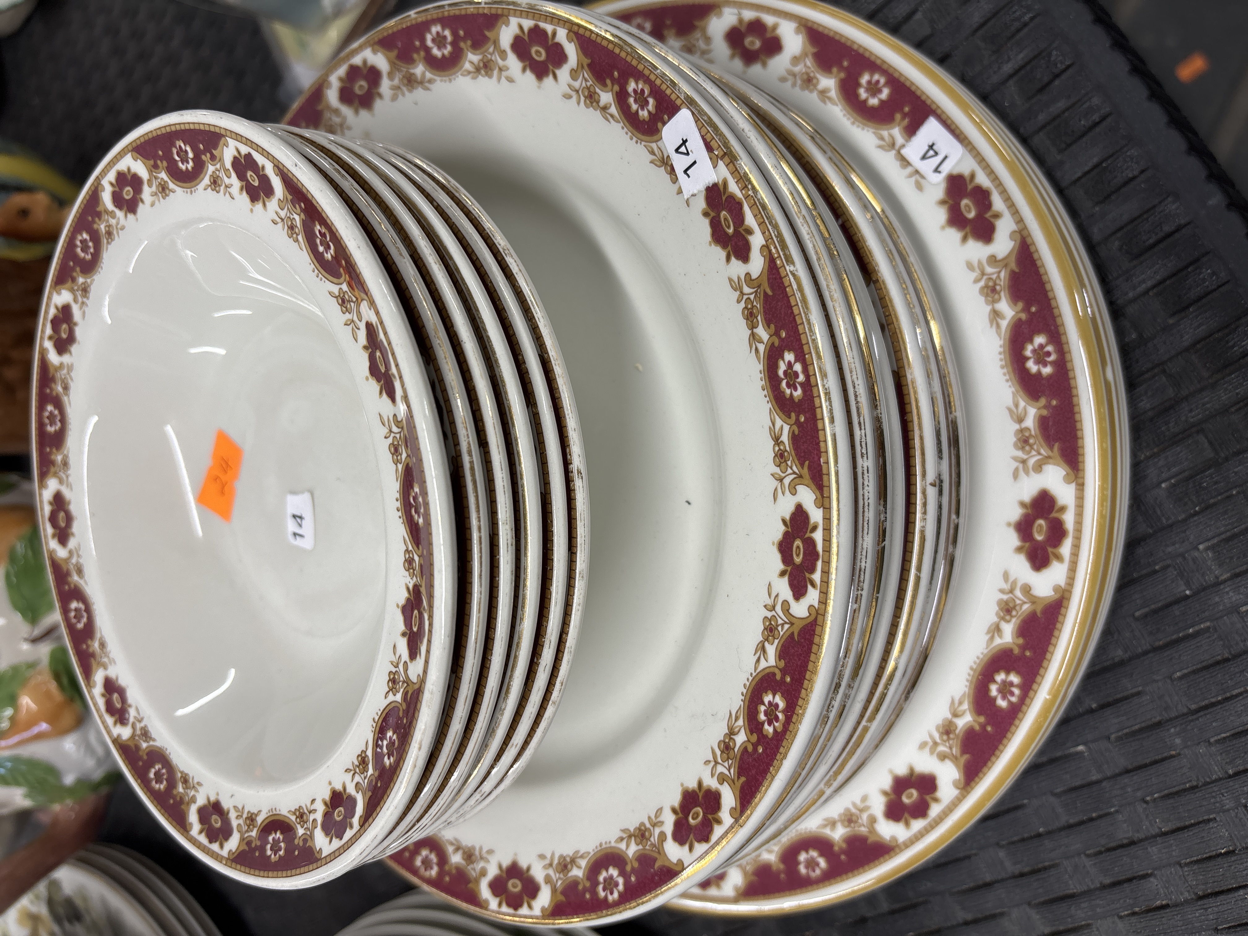 A Set of Twelve Porcelain Dinner Plates and Shallow Bowls with Maroon and Gilt Decoration