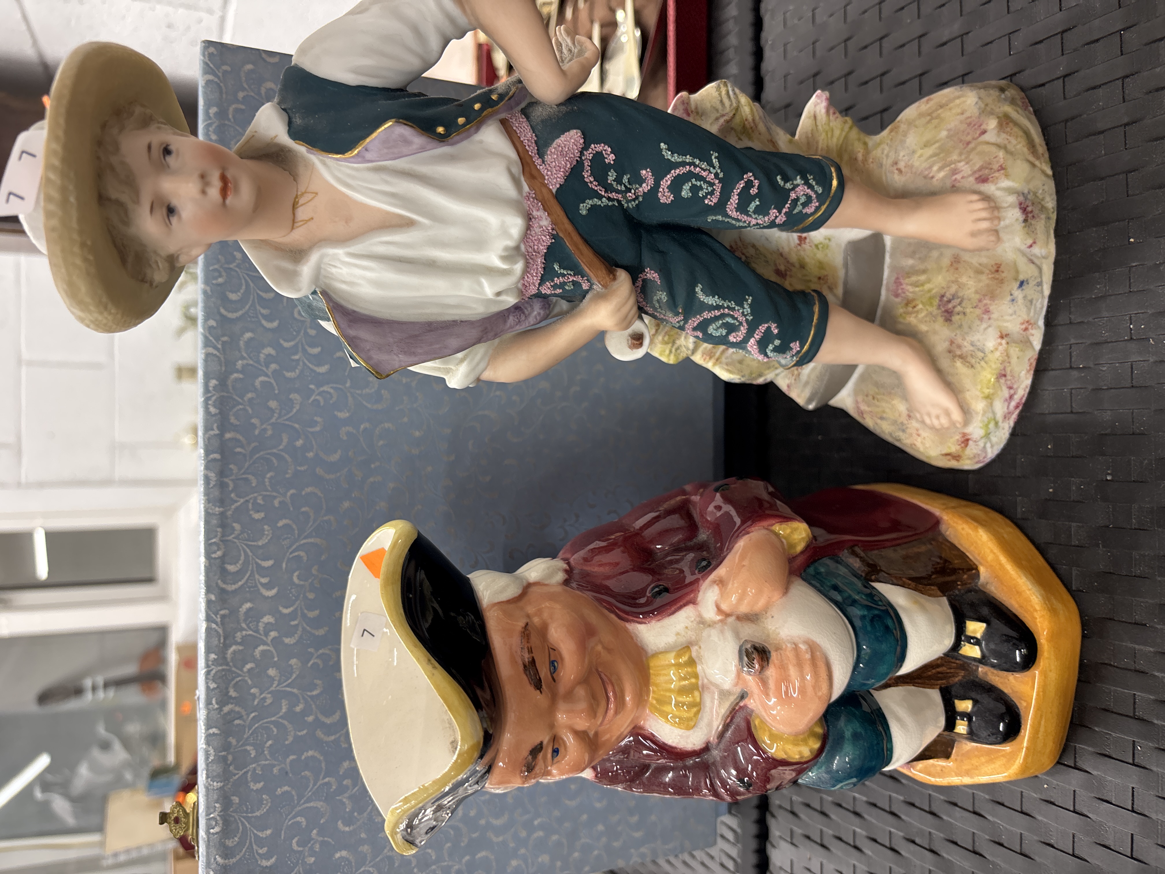 Two Ceramic Figurines including a Bisque Porcelain Youth and a Hearty Good Fellow Toby Jug