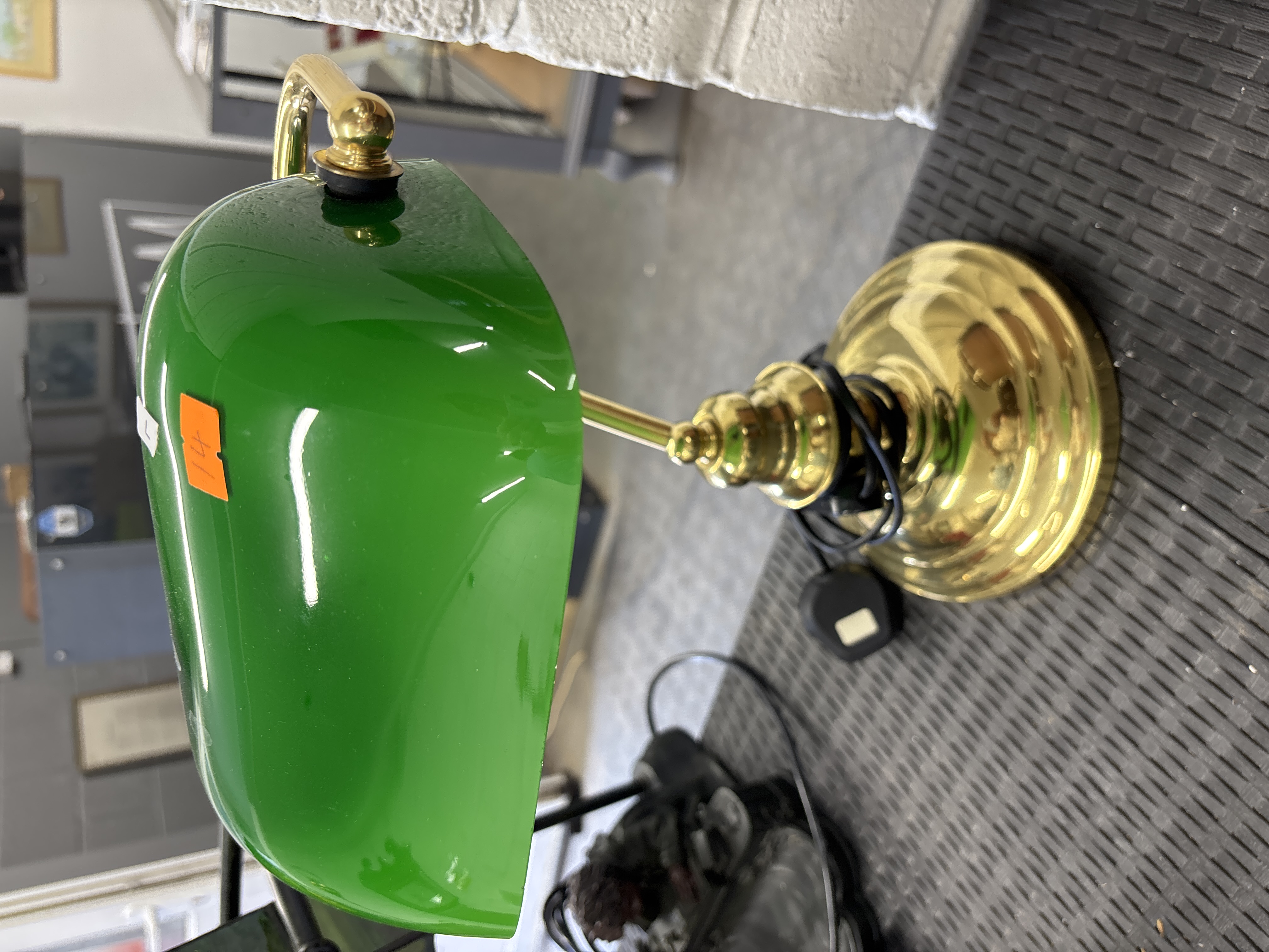 A traditional brass and emerald green cased glass bankers style desk lamp