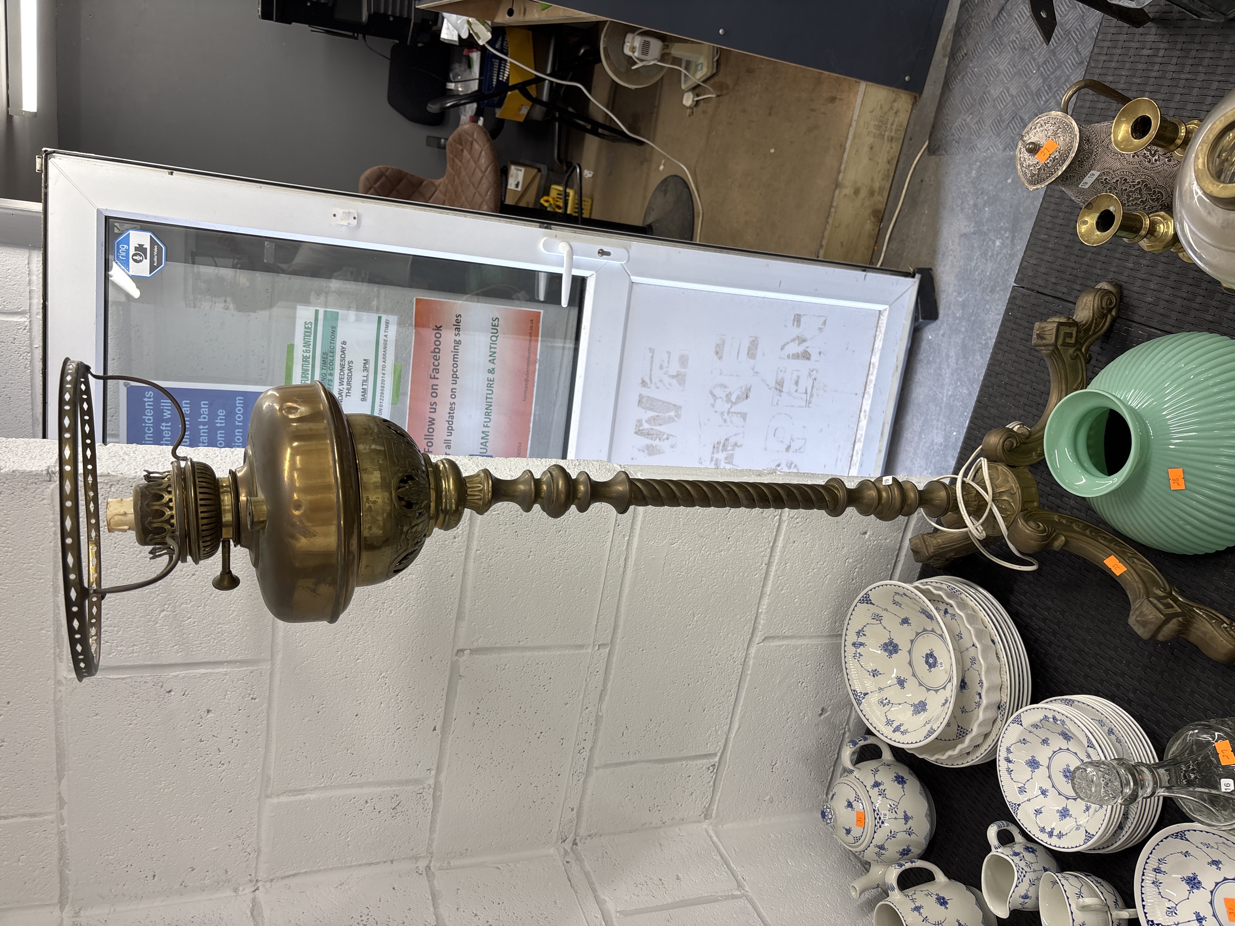 A Victorian revival brass floor lamp with a ribbed green glass shade