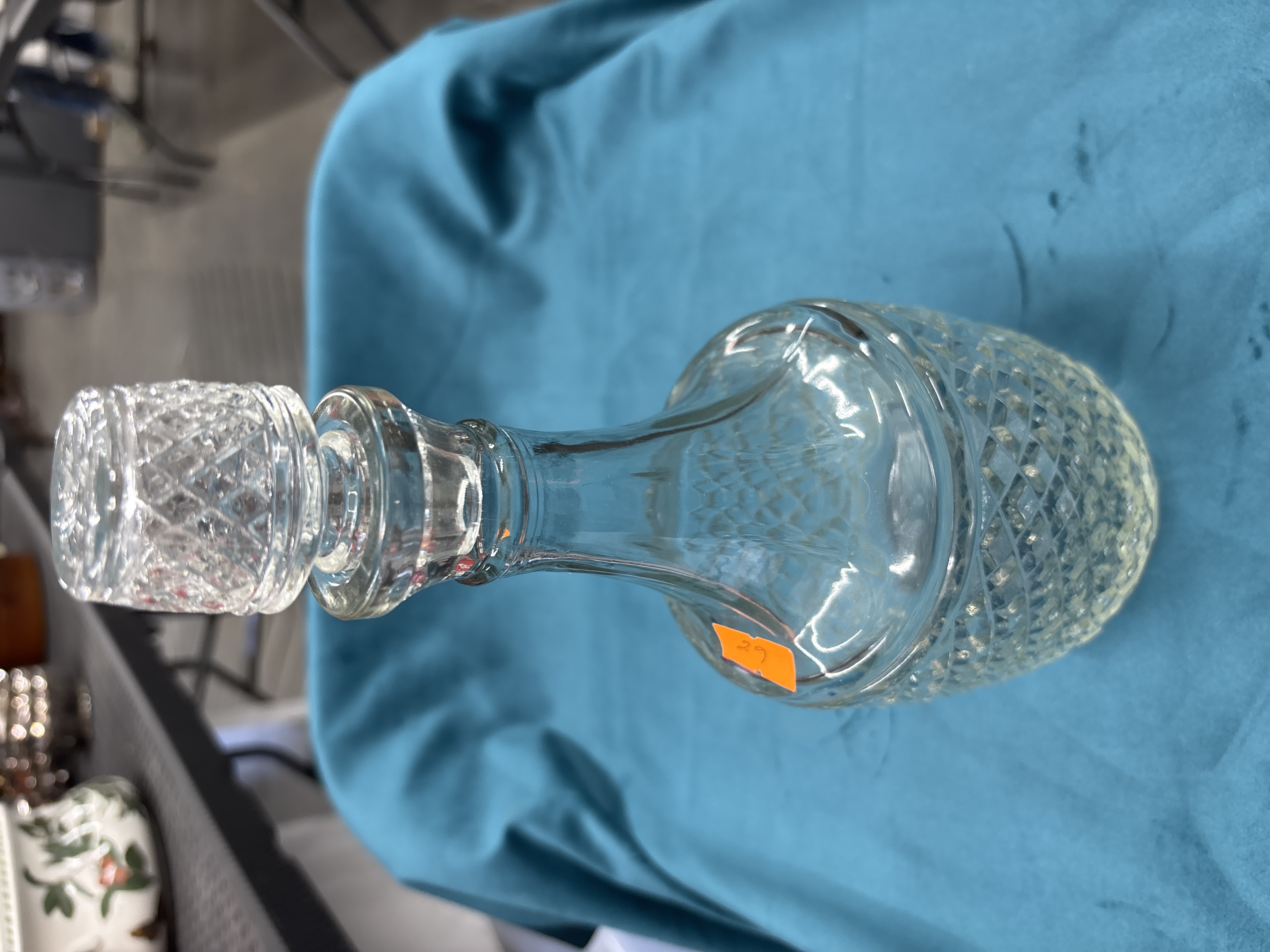 A Clear Glass Decanter with Diamond Cut Decoration and Matching Stopper