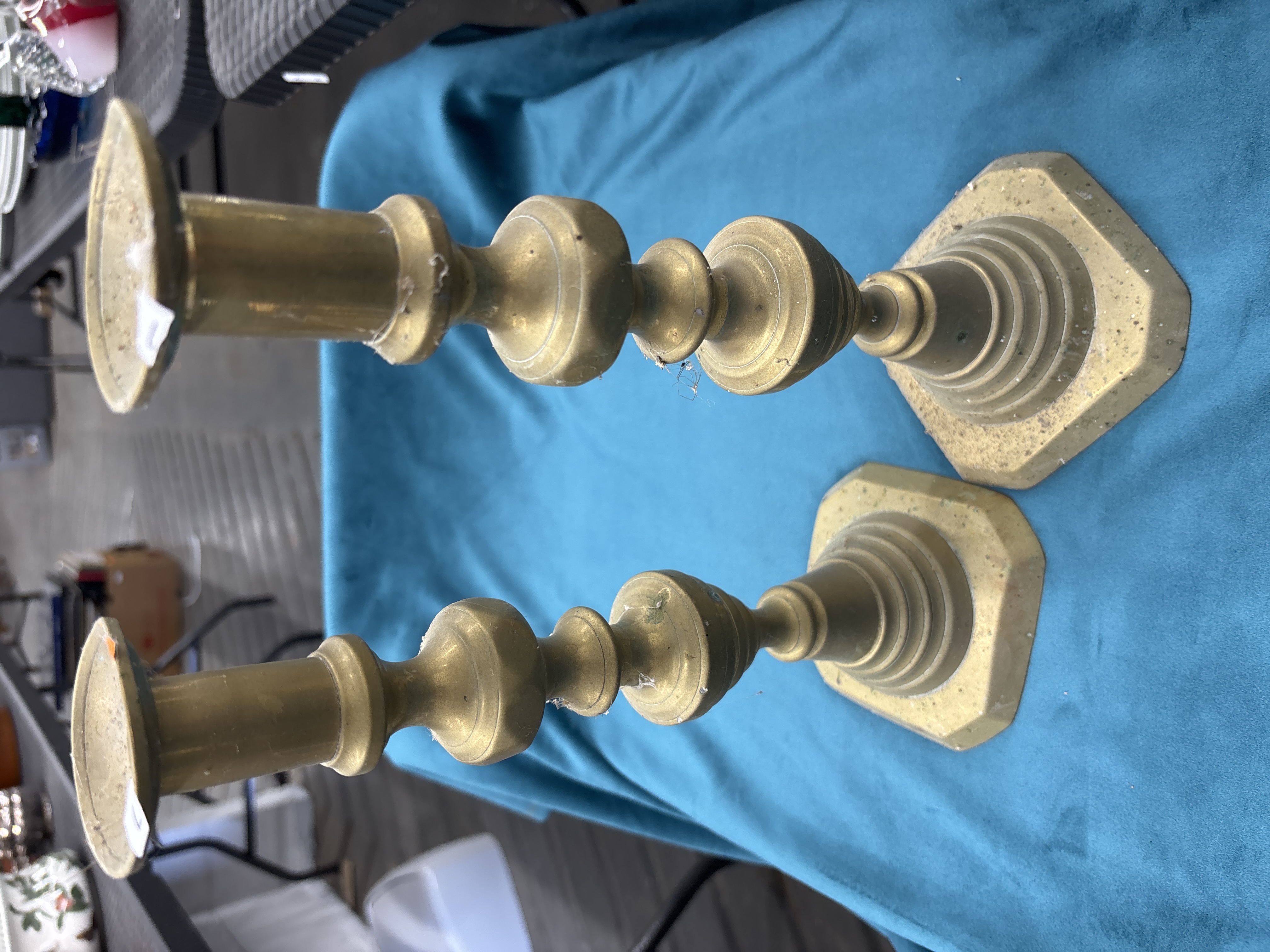 A pair of Queen Anne style cast brass candlesticks with octagonal bases