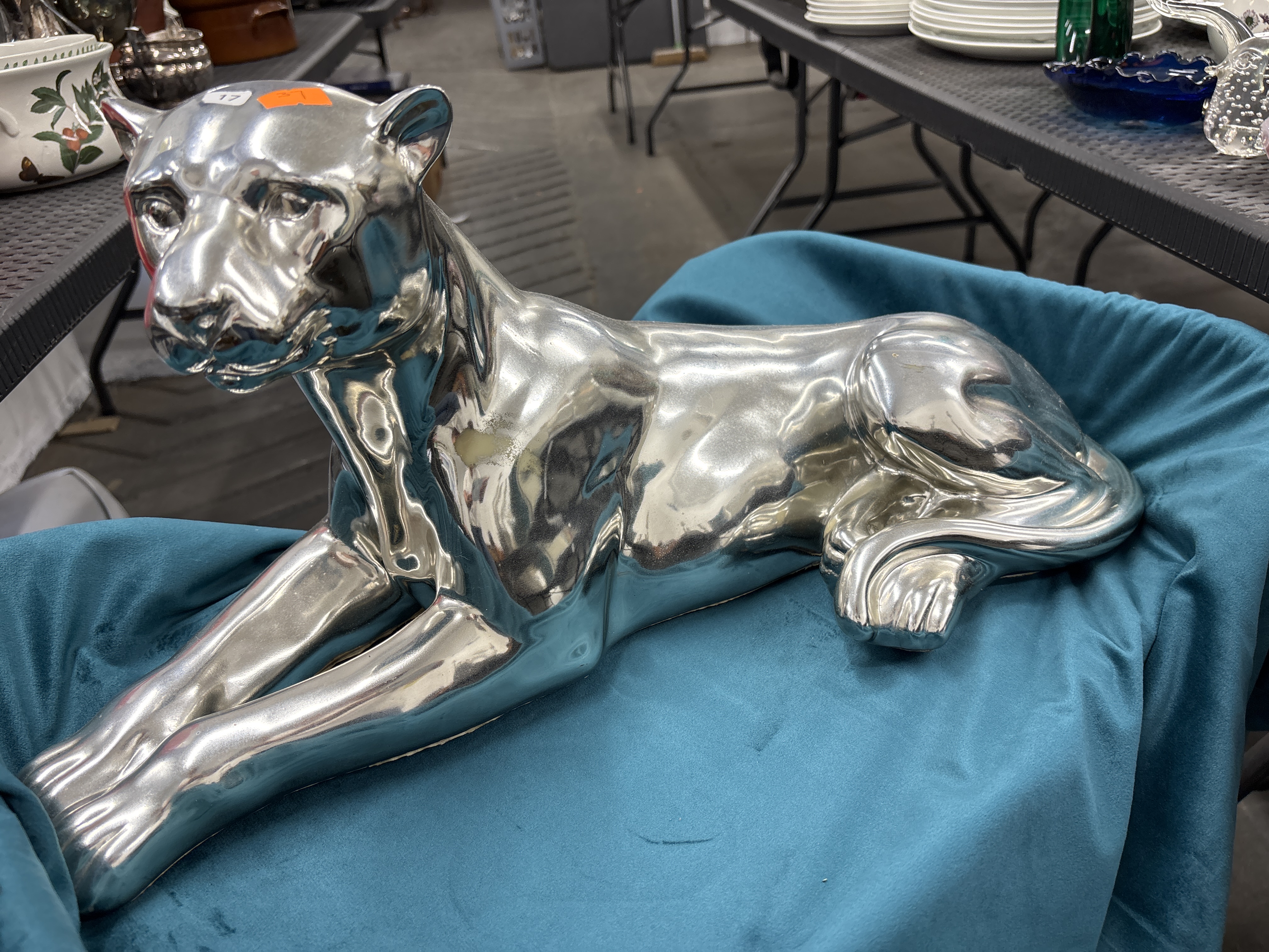 A large silver-toned electroplated ceramic figurine of a reclining panther