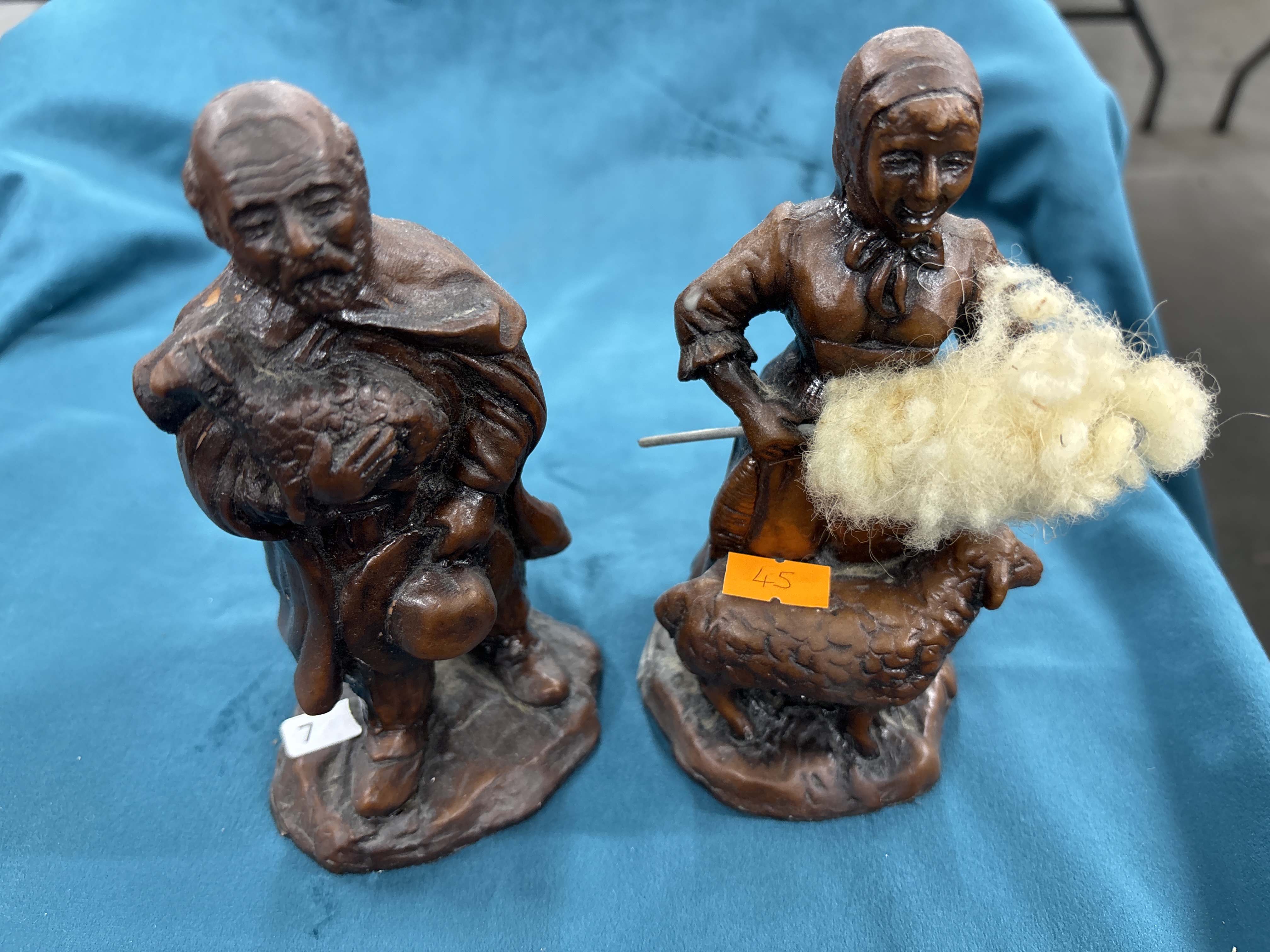 A Pair of Moulded Wood-Effect Resin Figurines Depicting a Shepherd and Shepherdess