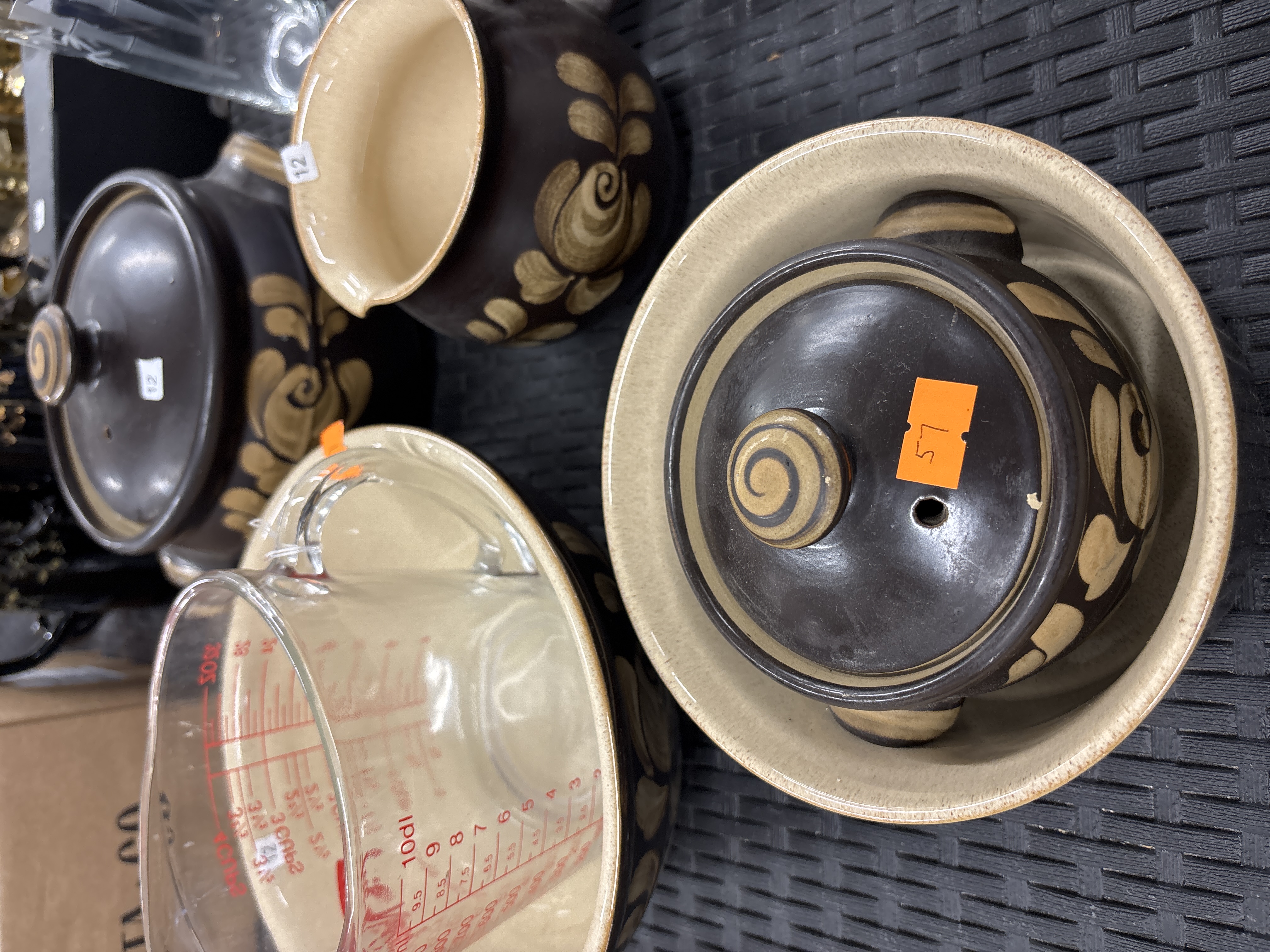 A collection of stoneware tableware and a glass measuring jug