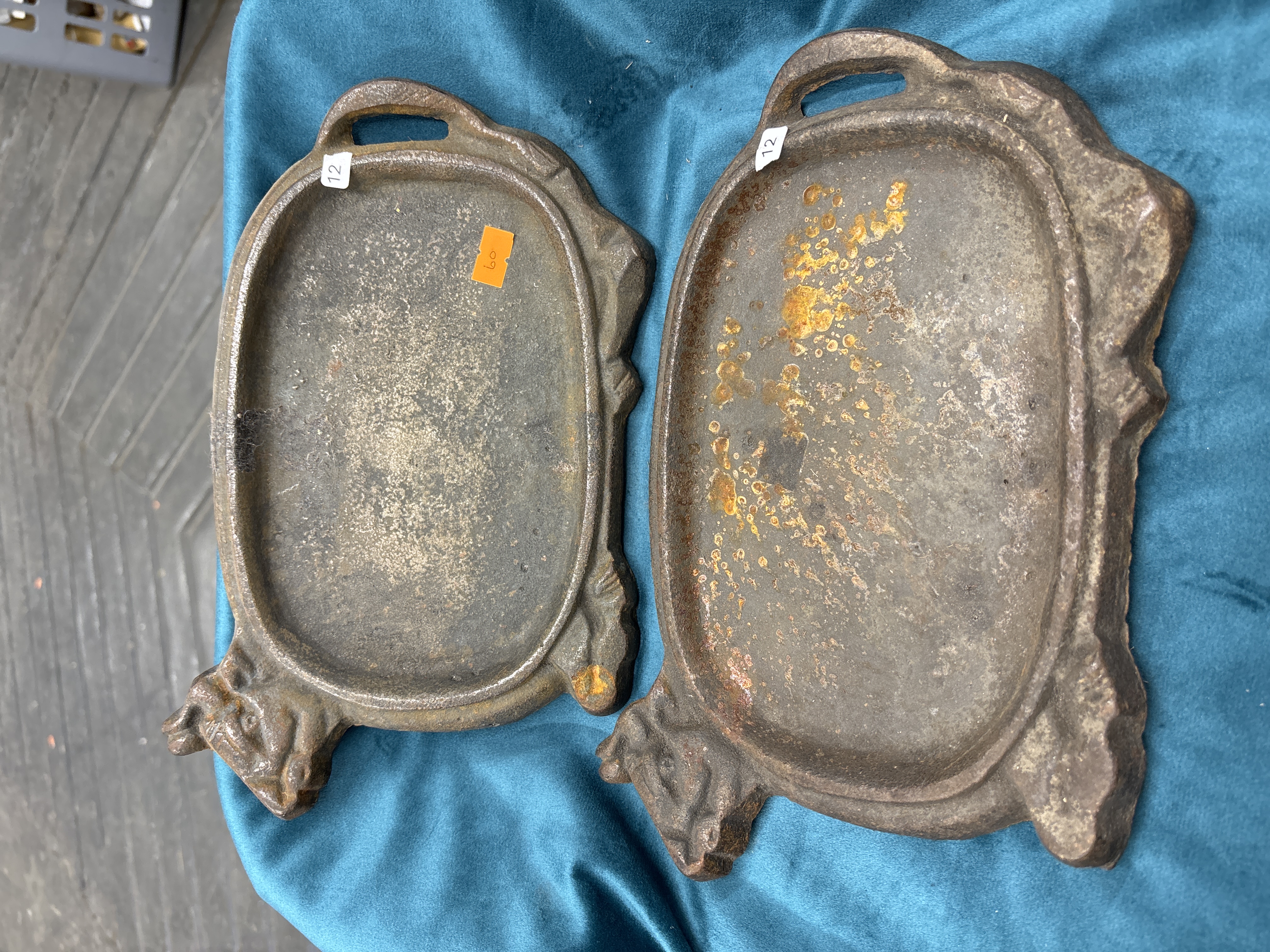 A Pair of Cast Iron Bovine Motif Sizzler Platters