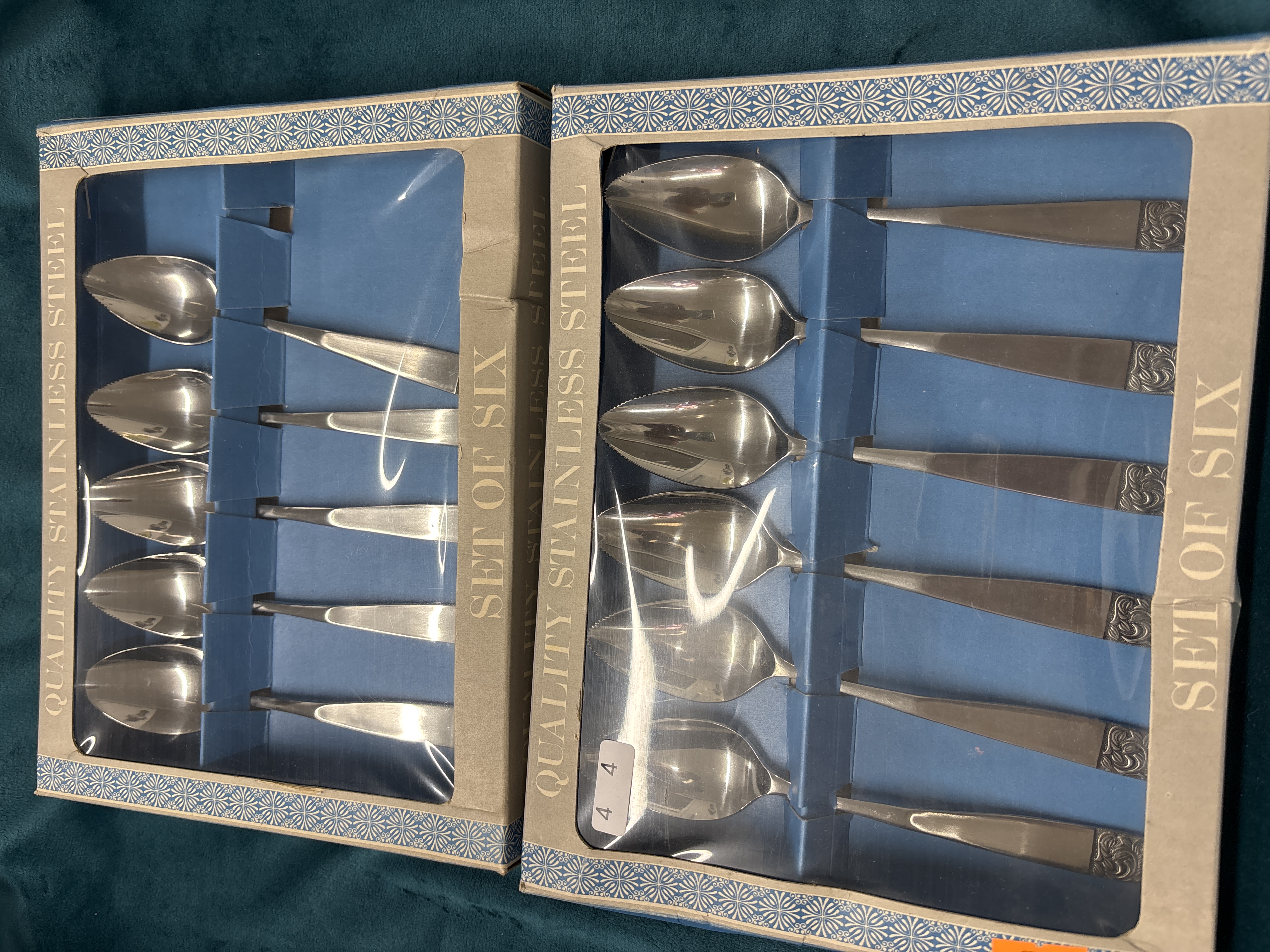 A Collection of Twelve Stainless Steel Grapefruit Spoons in Retail Packaging