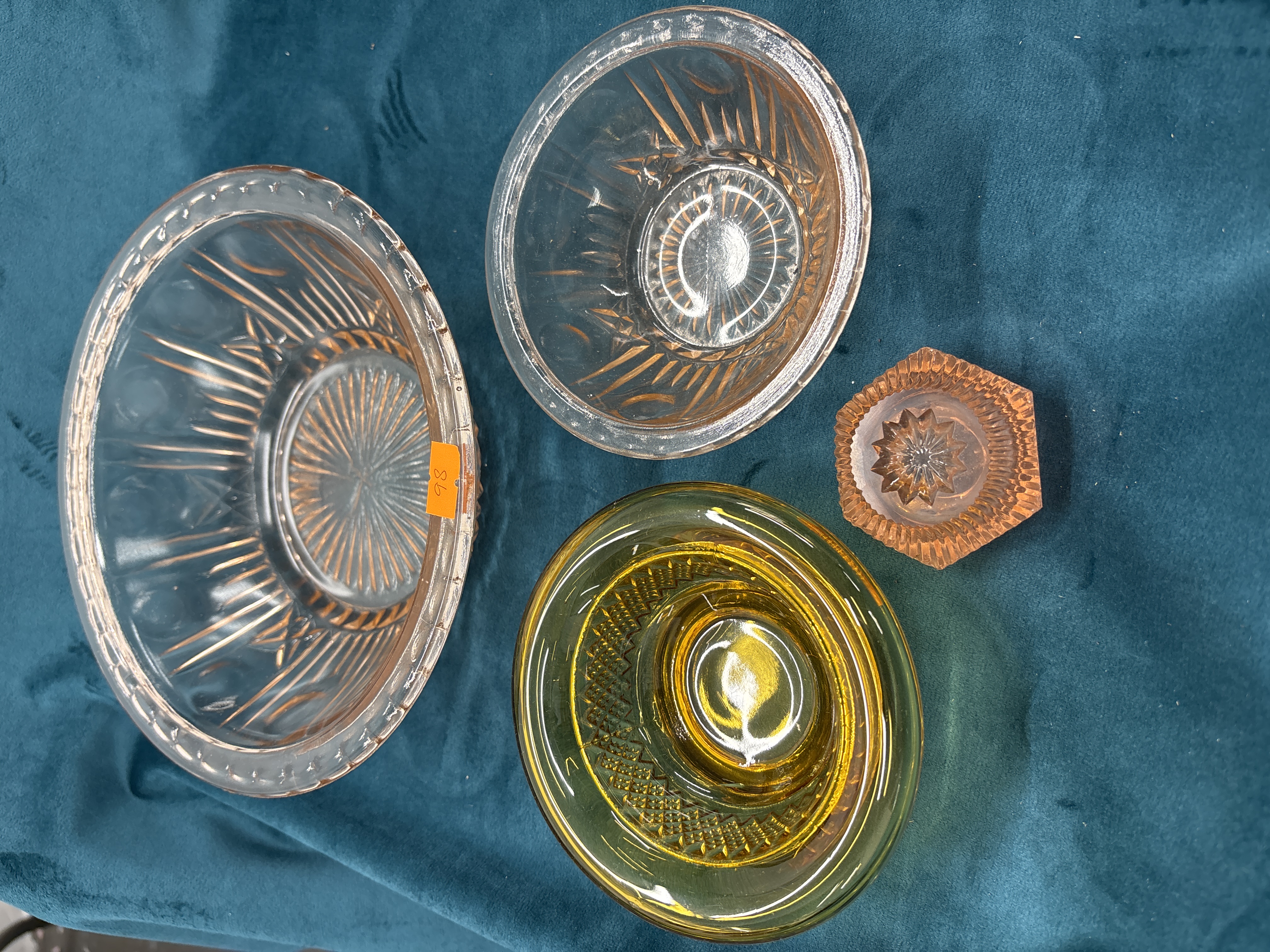 A collection of four pieces of vintage pressed glass