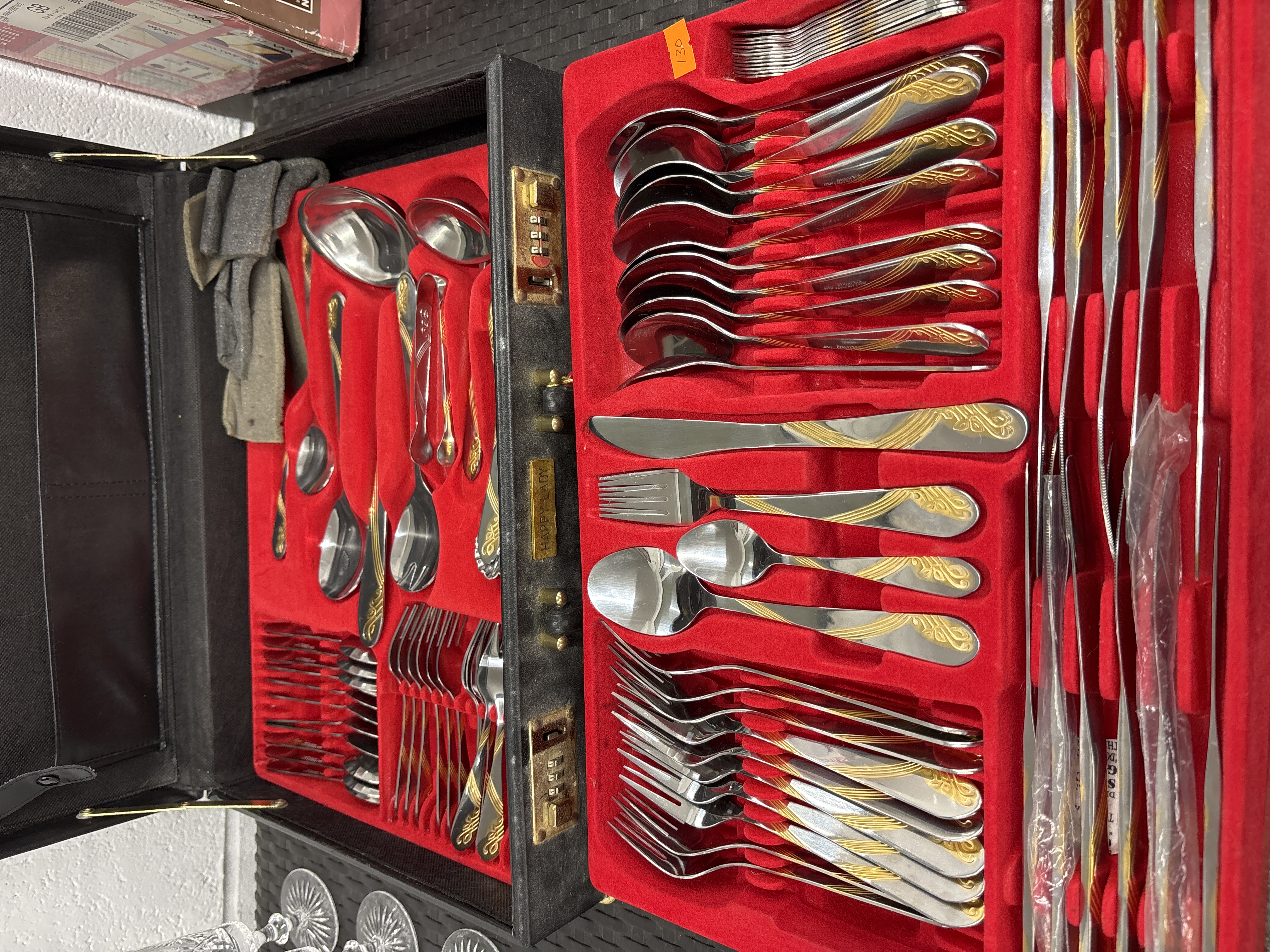 A Happy Lady Gold-Plated Stainless Steel Flatware Service in a Briefcase