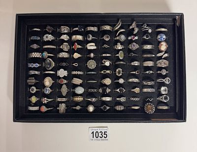 A good tray of 100 silver rings and white metal rings