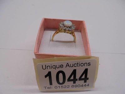 An 18ct yellow gold opal and diamond ring, size L half, 4.55 grams.