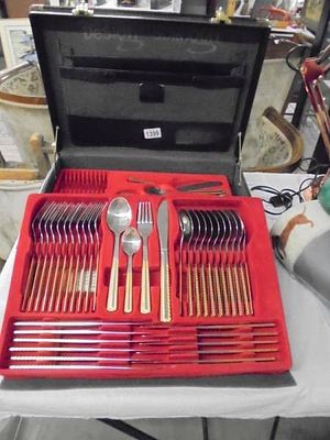 A Solingen 12 place setting canteen of cutlery with gilt details in a briefcase style case.