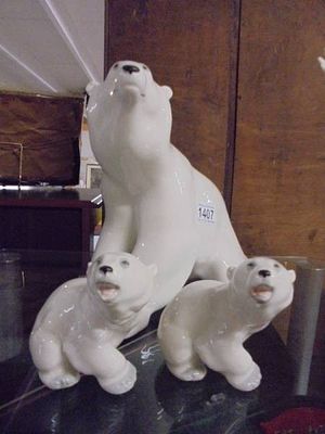 A large Russian Lomonosov porcelain Polar bear with two cubs. Height 26cm and 11.5cm