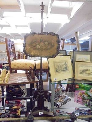 A Victorian mahogany pole screen.