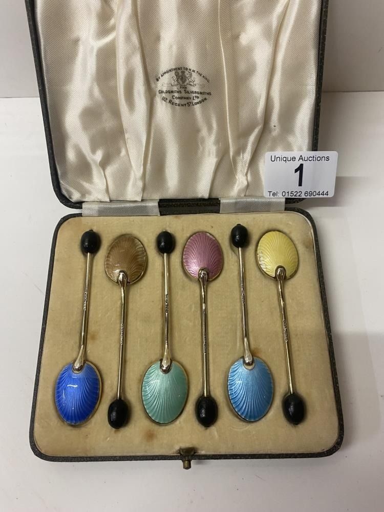A cased set of six silver and enamel spoons