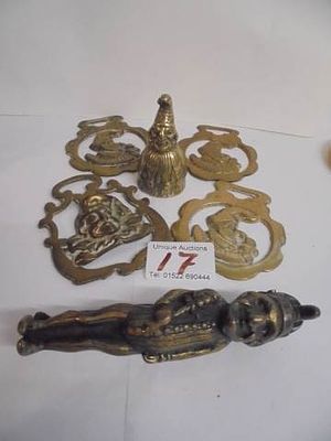 A collection of brassware related to Punch &amp; Judy including nutcracker, bell and horse brasses.