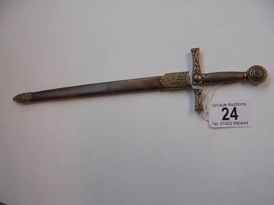 A letter opener fashioned as a sword in scabbard in good condition.