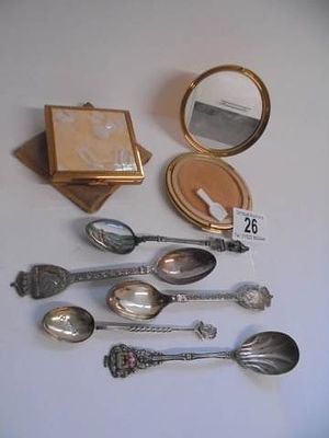 Two Stratton powder compacts and five spoons including two silver and an enamel example.
