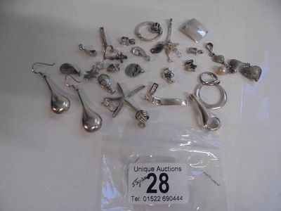 Approximately 30 silver pendants, 55 grams.