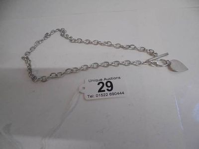 A 20th century silver neck chain with heart pendant.
