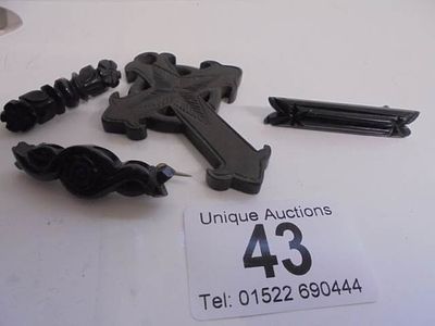 Three Whitby style brooches and a cross.