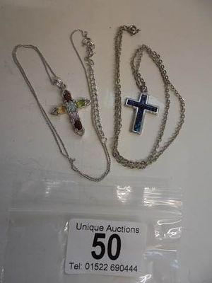 Two white metal cross pendants on chains including one stone set.