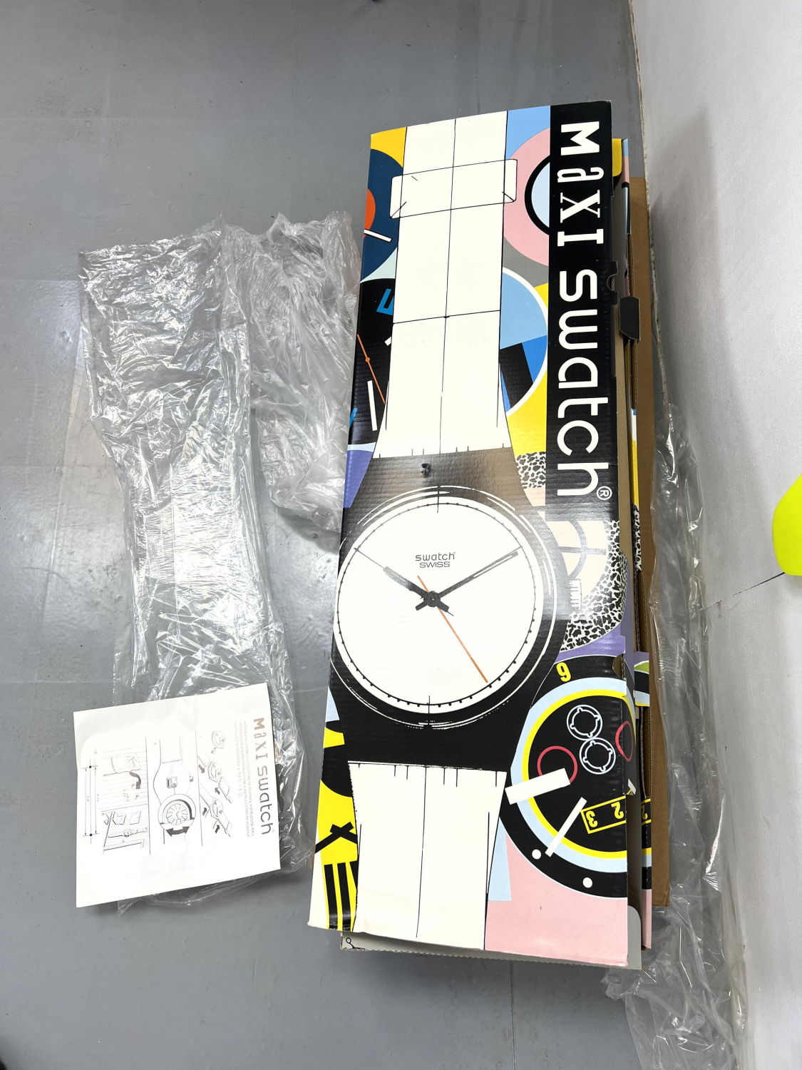 Lot 1393 - New old stock MAXI Swatch CAUTION Wall clock watch form