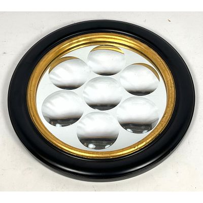 Fornasetti style Framed Round Dimpled Mirror. Ebonized and gilt wood frame Dimensions: Height: