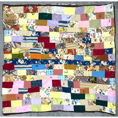 Vintage patchwork tied quilt features a staggered rectangular block. Machine made. Dimensions: 