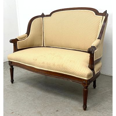 Louis XVI style walnut settee love seat featuring a curved, molded crest rail and an 