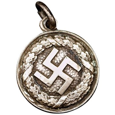 NSDAP Sympathizer Swastika Pendant. A small round pendant featuring a raised swastika at center 