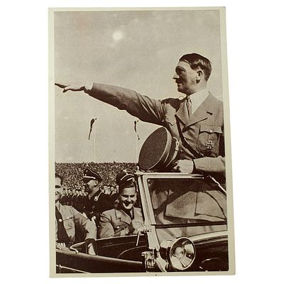 Adolf Hitler Propaganda Postcard. A photographic postcard depicting a uniformed figure standing 