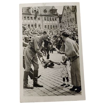 Adolf Hitler Propaganda Postcard. A period photo postcard depicting a uniformed official bending 
