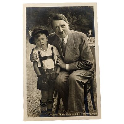 Adolf Hitler Propaganda Postcard. A printed postcard depicting a seated man in a suit with his 