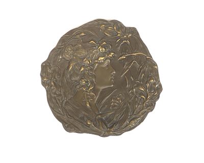 A brass wall plaque, circa 1900 A patinated brass wall plaque decorated with a young lady seen 