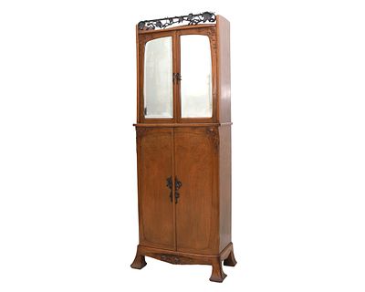 Art Nouveau. Edgar Brandt (1880-1960). A walnut mirror cabinet with cast-iron frieze under which 