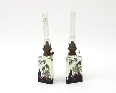 N.V. Haagsche Plateelfabriek Rozenburg, The Hague Two polychrome painted earthenware oil lamps 