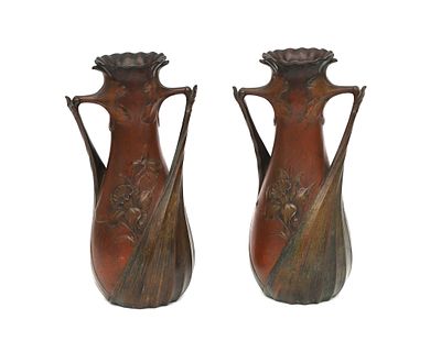 L&eacute;on Kann (1859-1925) Two patinated bronze vases with relief decoration of daffodils and two 