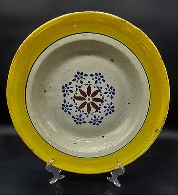 Large Earthenware Deep Plate. From the north with a yellow painted border, to the center with 