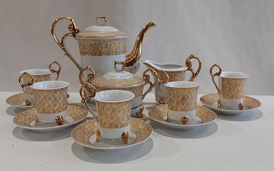 European Porcelain Coffee Service
. Molded and relief, unmarked, gold decoration on a white 