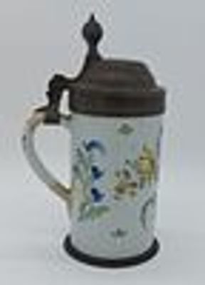 Faience Beer Mug
. 19th century, polychrome floral decoration on a white glazed background, with 