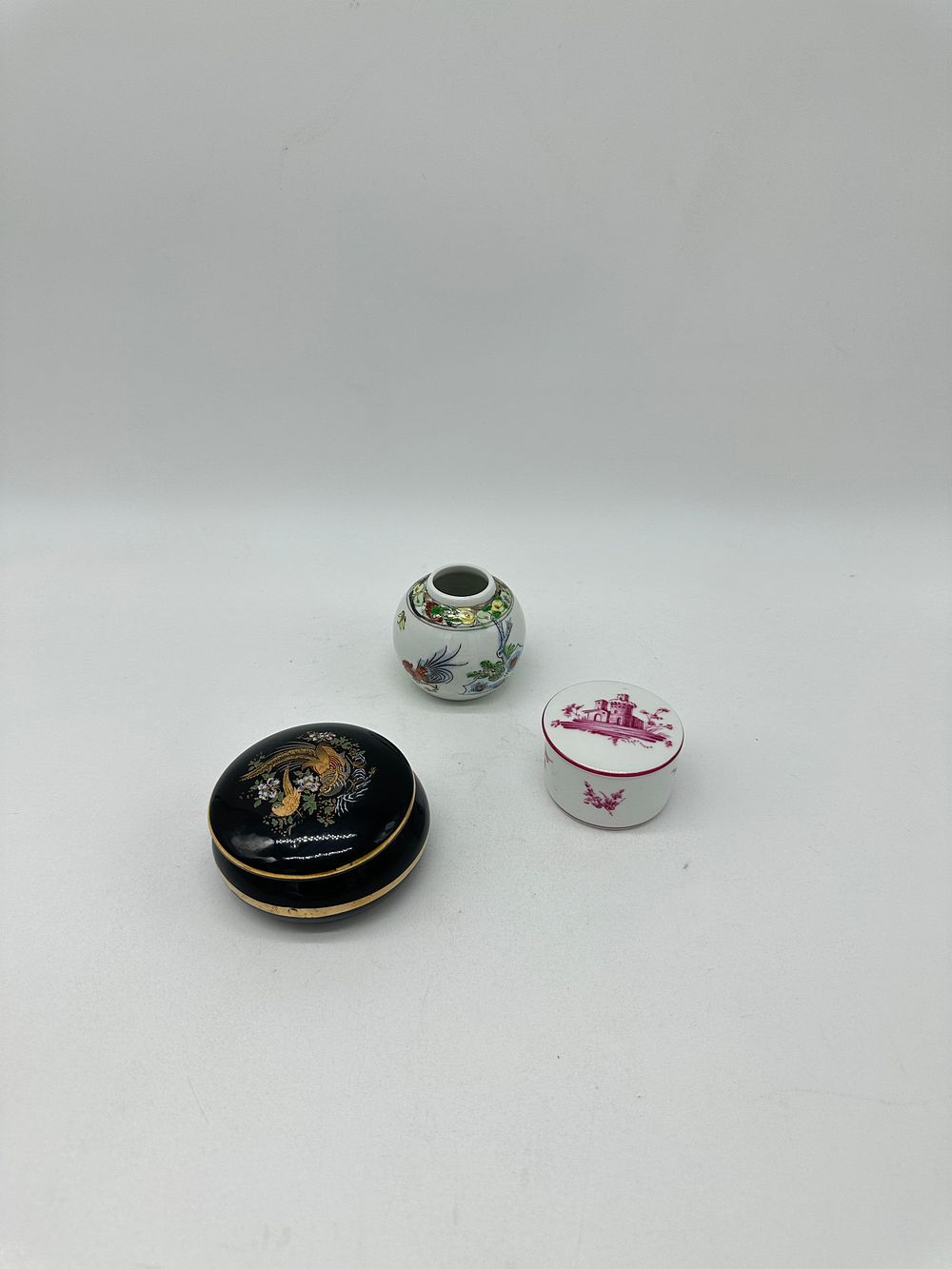 Three Porcelain Pieces
. Molded and relief, marked on the base, two boxes and a pot, with floral 