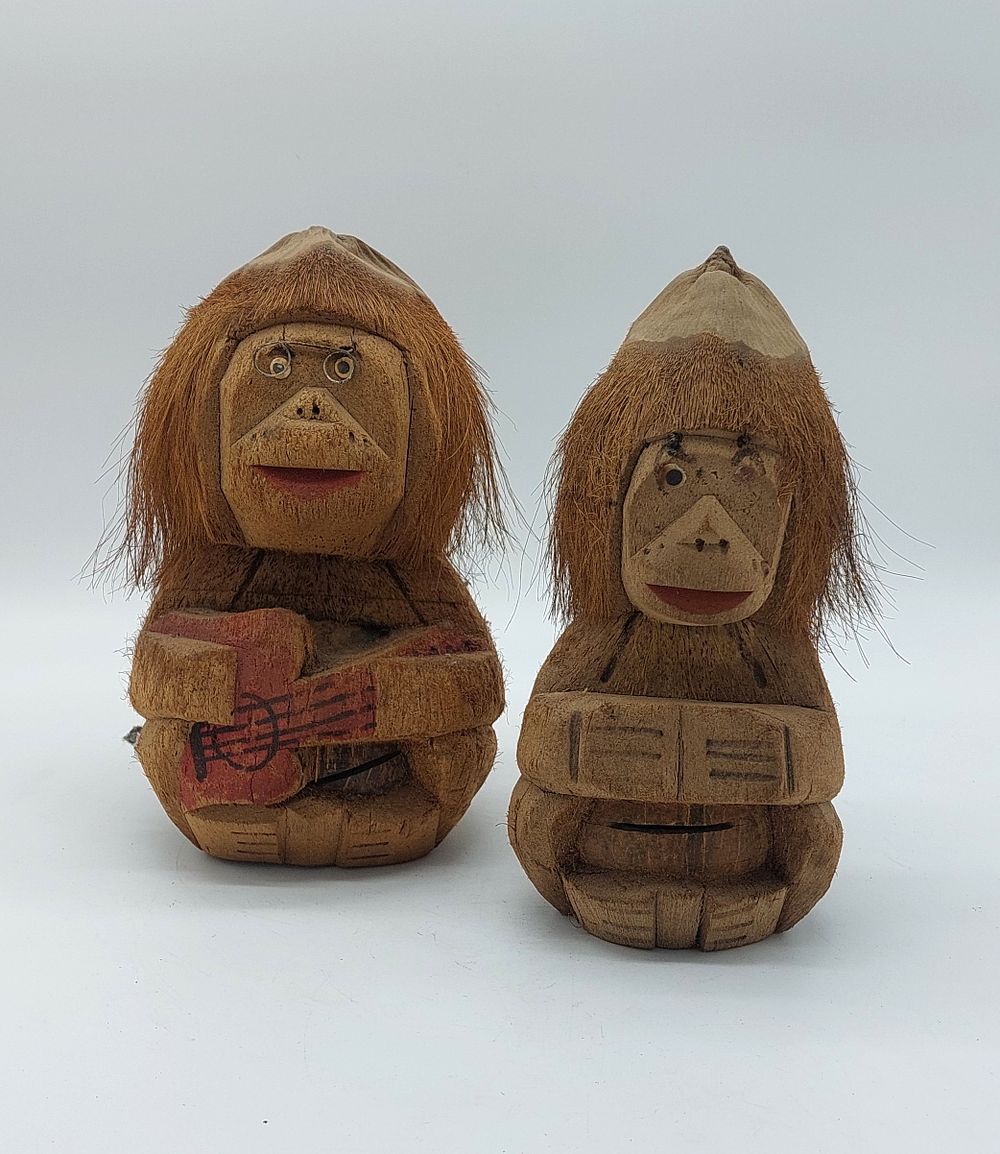 Coconut Crafts
. Pair of sculptures representing seated animals with relief carving showing 