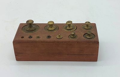 Wooden Block with Weights
. Rectangular body with eleven round cavities of various shapes with