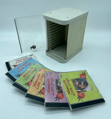 CD stand with six CDs. Plastic-bodied stand with space for 12 CDs with transparent acrylic