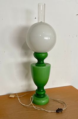 Table Lamp
. Green glass body with transparent glass chimney with round white dome. It is 78 cm high.