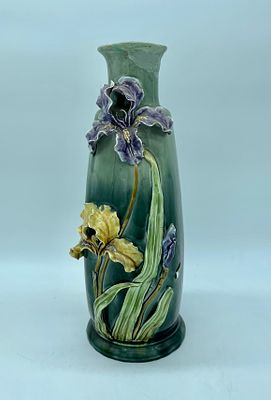 Porcelain vase, base painted green with floral motif sculptures in polychrome biscuit