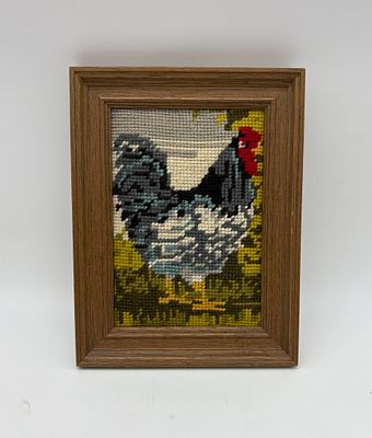 Frame with embroidery. Rectangular wooden frame with embroidery depicting a rooster. The frame 
