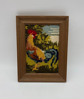 Frame with embroidery. Rectangular wooden frame with embroidery depicting a rooster. The frame 