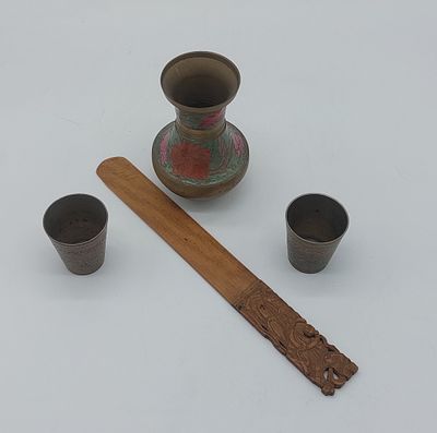 Decorative Pieces
. Metal jug, two metal glasses and wooden paper cutter, with chiseled and 